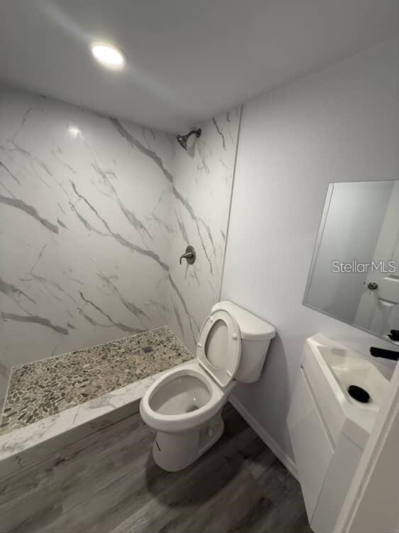 5500 North Rome Avenue, Unit 29 Tampa, FL 33603 - Photo 10 of 10 a white toilet sitting next to a bathroom sink