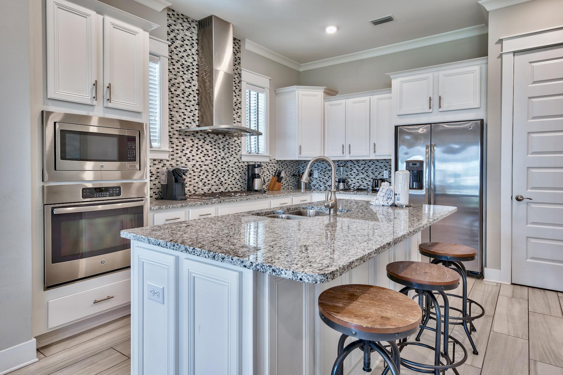 46 York Ln Inlet Beach, Unit B Inlet Beach, FL 32461 - Photo 8 of 33 a kitchen with stainless steel appliances granite countertop a sink refrigerator and cabinets