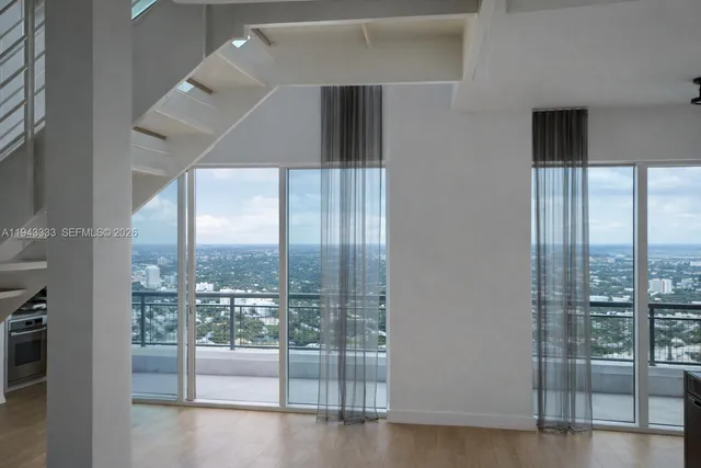 a view of a kitchen with a sink stove and refrigerator