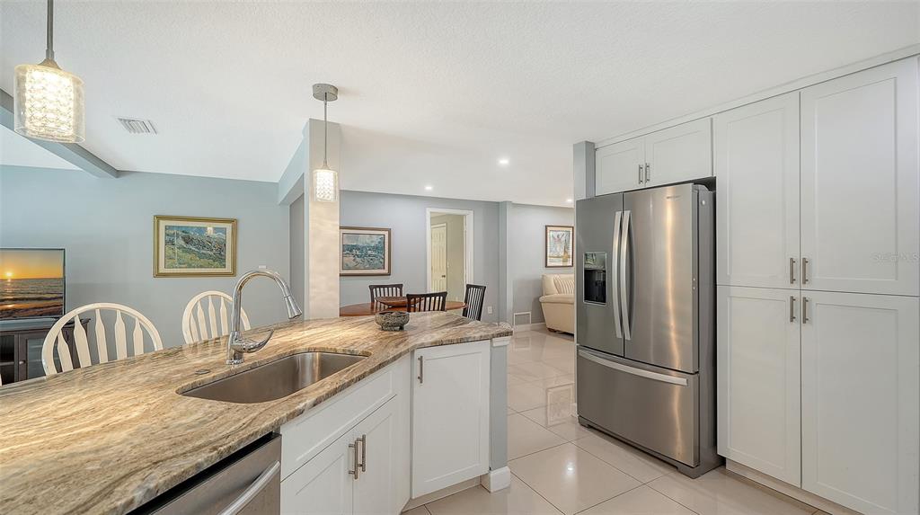 1523 84th Street Northwest Bradenton, FL 34209 - Photo 14 of 48 a kitchen with granite countertop a refrigerator and a sink