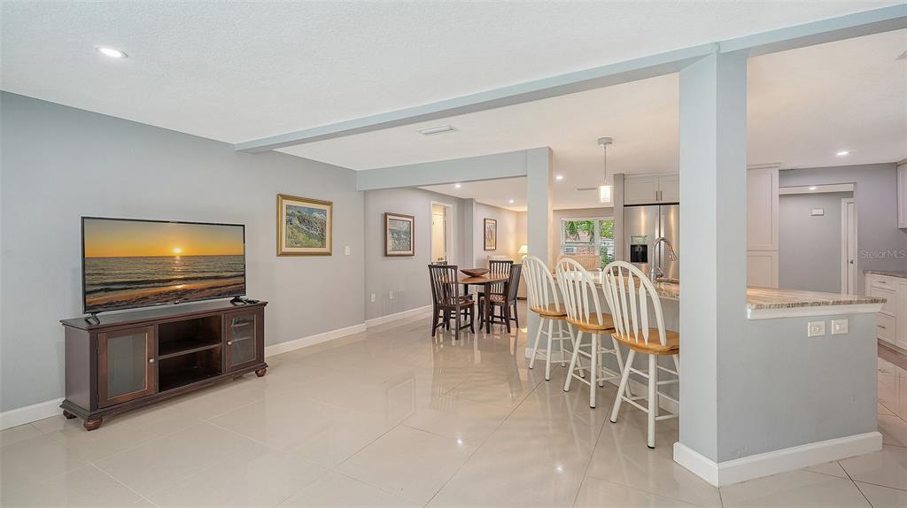 1523 84th Street Northwest Bradenton, FL 34209 - Photo 16 of 48 a living room with furniture a flat screen tv and kitchen view