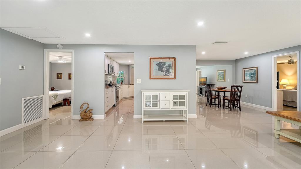 1523 84th Street Northwest Bradenton, FL 34209 - Photo 17 of 48 a living room with furniture a dining table and a large window