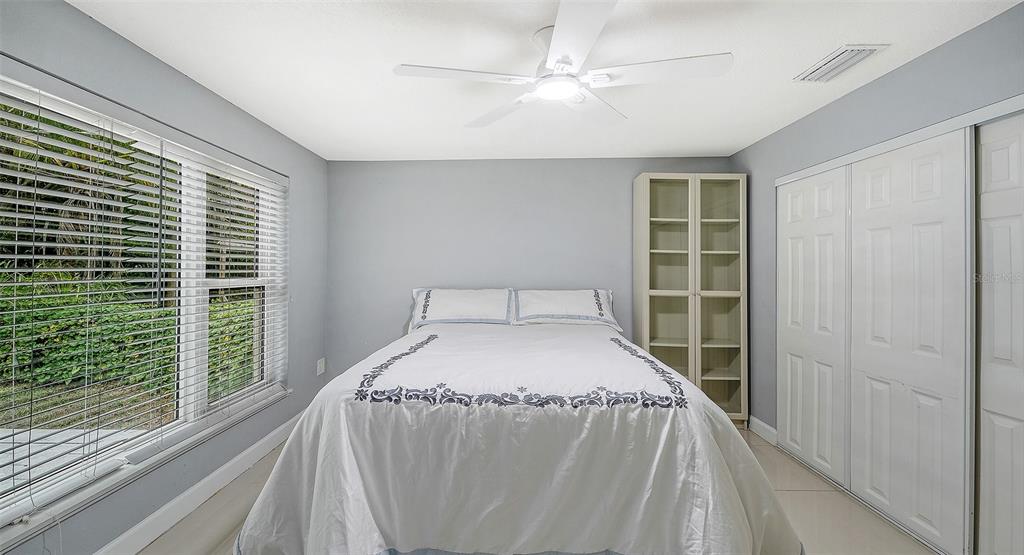1523 84th Street Northwest Bradenton, FL 34209 - Photo 28 of 48 a bed sitting in a bedroom next to a window
