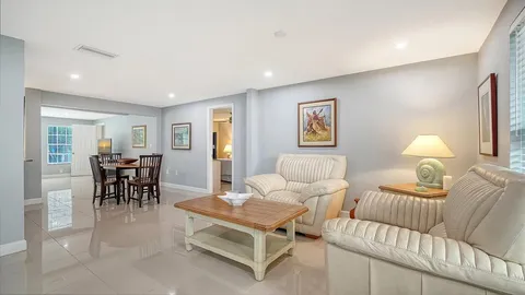 a living room with furniture windows and flat screen tv