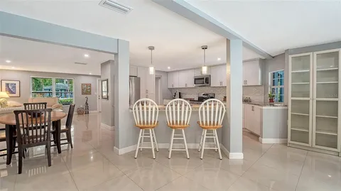 a kitchen with granite countertop a refrigerator and a sink