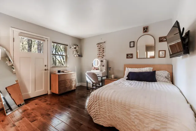 a view of a room with wooden floor and bathroom