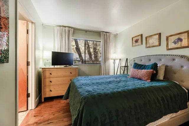 a bedroom with a large bed and a window