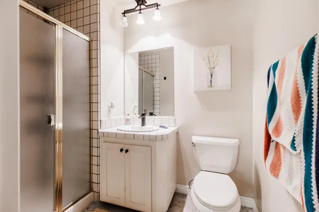 a en suite bathroom with a double vanity sink and a mirror