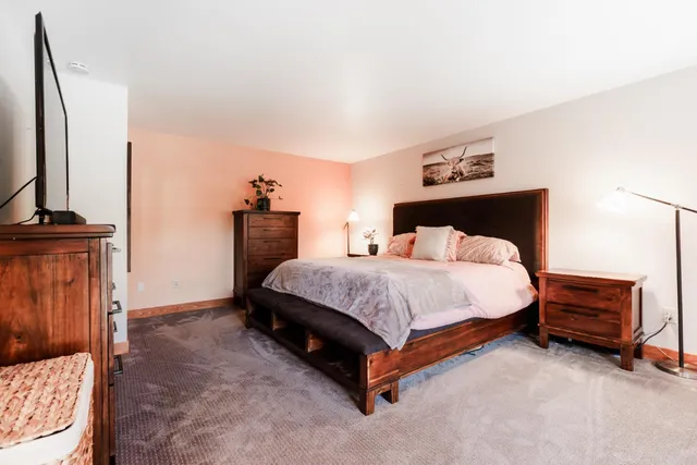 a bedroom with a large bed and a large window