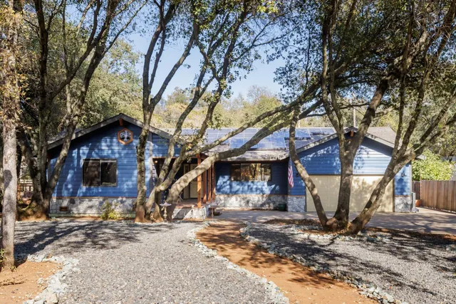 a backyard of a house with barbeque oven and outdoor seating