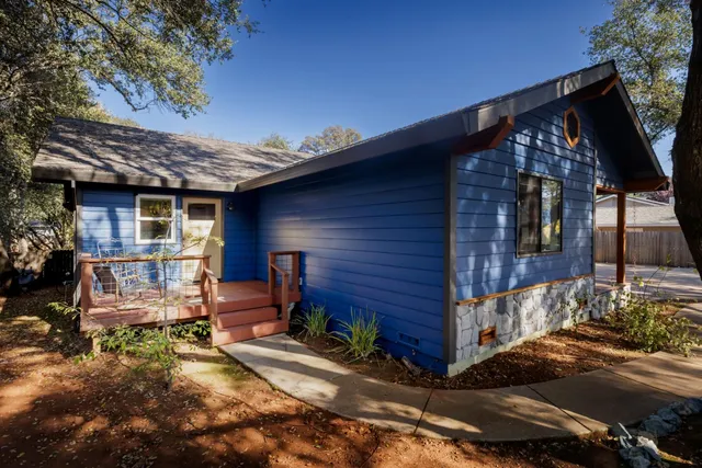 a view of a backyard with a patio and fire pit