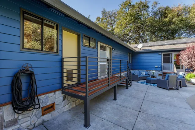 a view of a swimming pool with lounge chairs in patio