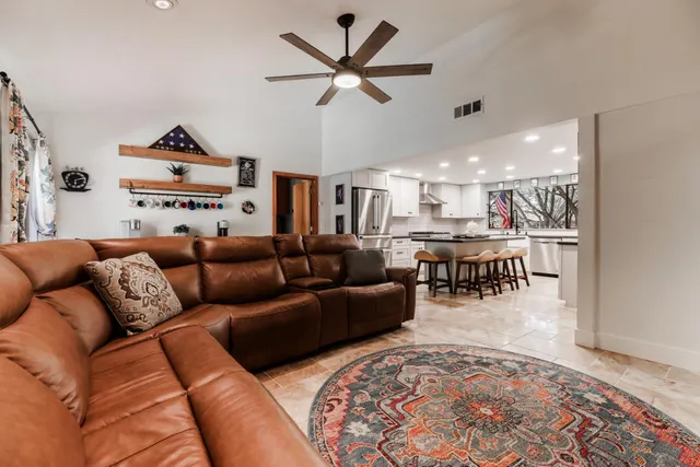 a living room with furniture and a chandelier