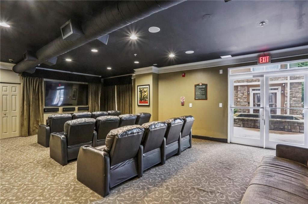 10 Perimeter Summit Boulevard, Unit 3206 Atlanta, GA 30319 - Photo 28 of 35 a media room with lots of chairs and a projector screen