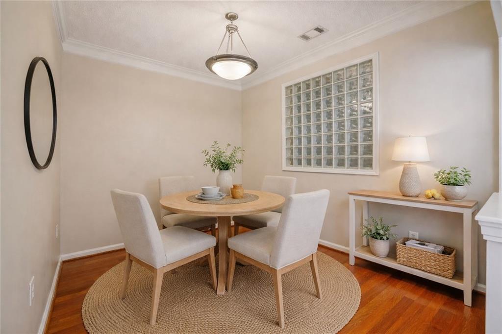 10 Perimeter Summit Boulevard, Unit 3206 Atlanta, GA 30319 - Photo 4 of 35 a view of a dining room with furniture and wooden floor