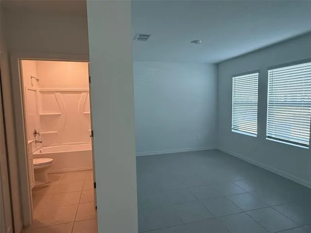 a view of an empty room with a window