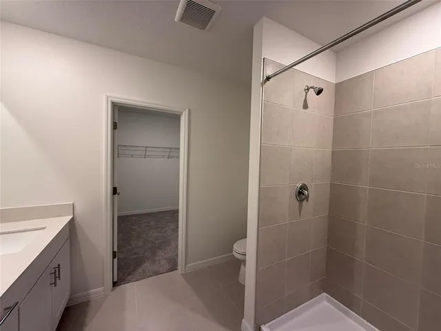 a bathroom with a shower and sink