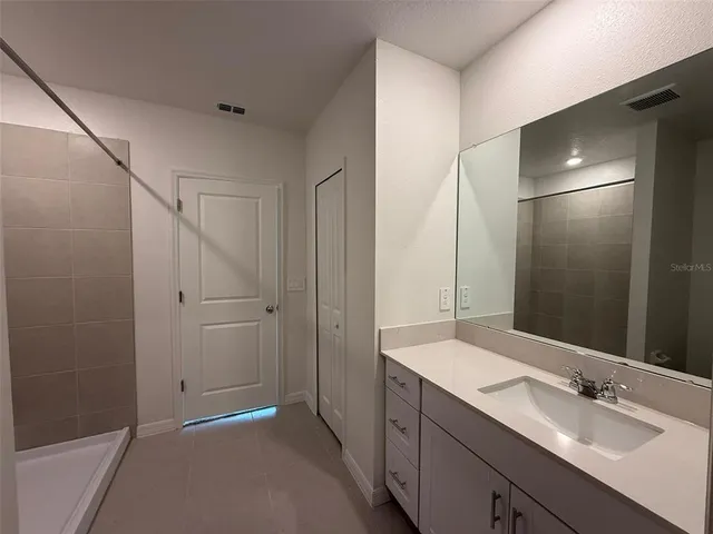 a bathroom with a double vanity sink and mirror