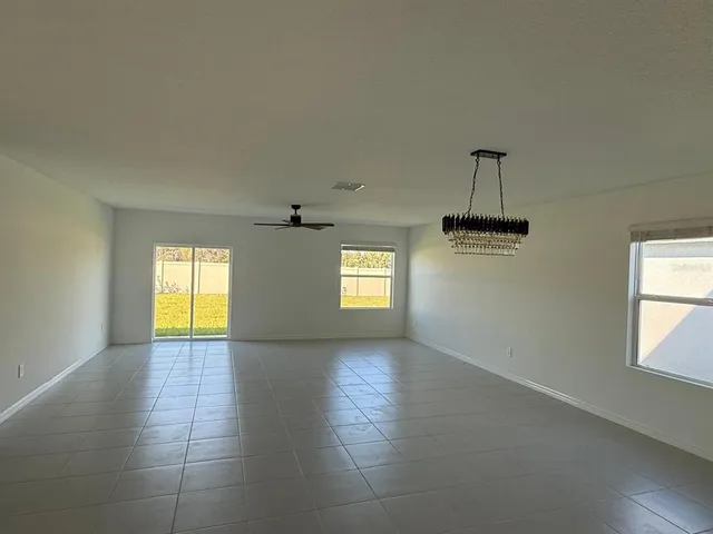 a view of empty room with wooden floor and window