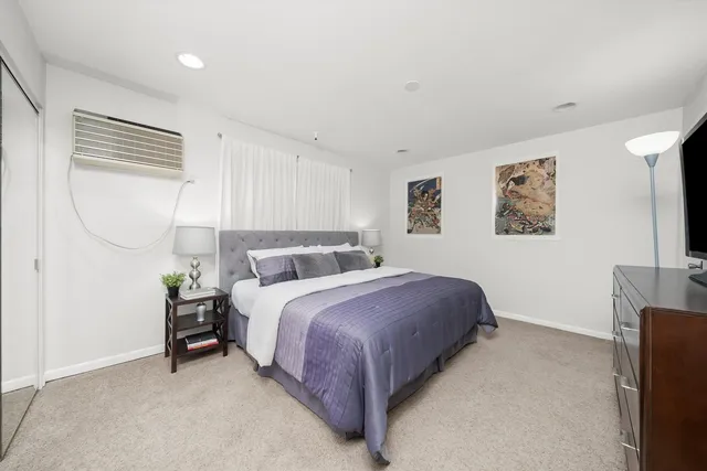 a bedroom with bed and a window