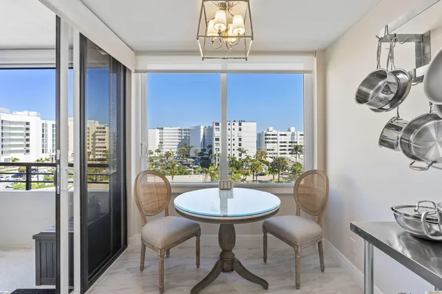 a kitchen with a table chairs and chandelier