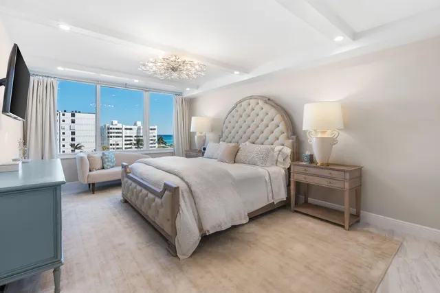 a bedroom with a bed and a chandelier