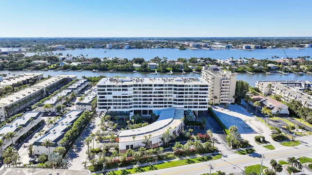 an aerial view of a house with a garden and lake view
