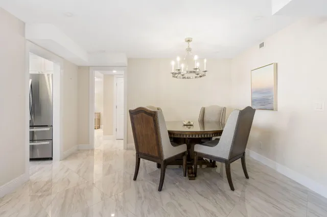 a view of a dining room with furniture and chandelier