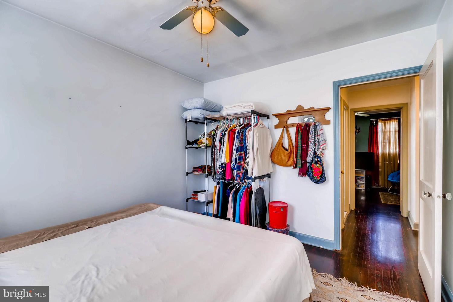 3703 Greenvale Road Baltimore, MD 21229 - Photo 19 of 24 a bedroom with a bed and a chandelier