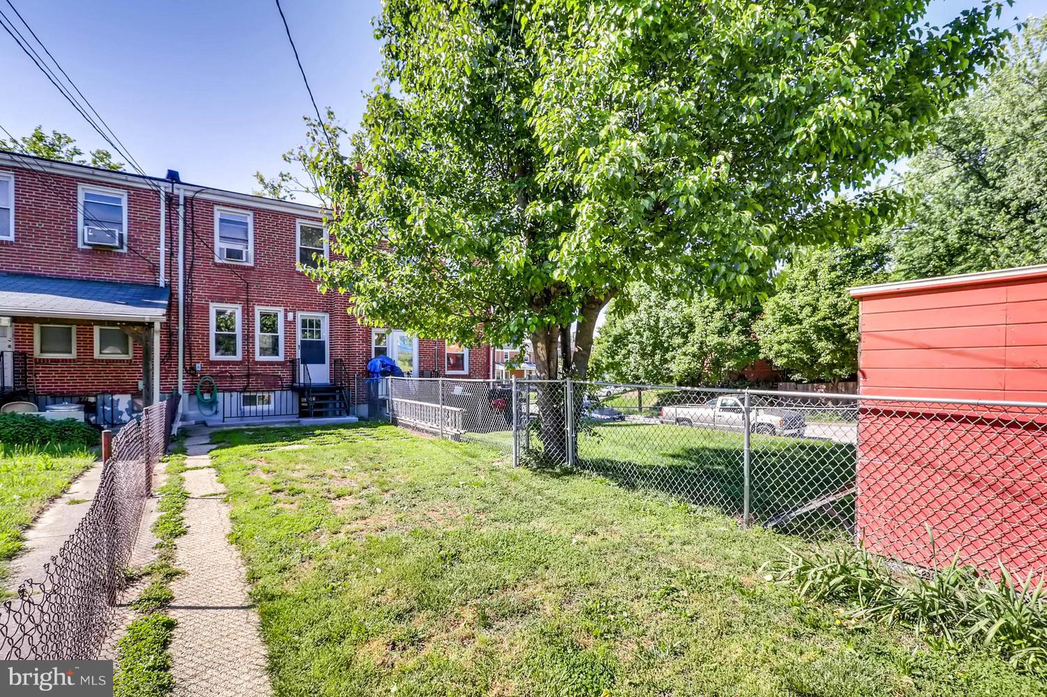 3703 Greenvale Road Baltimore, MD 21229 - Photo 23 of 24 a view of a backyard with table and chairs potted plants and a large tree