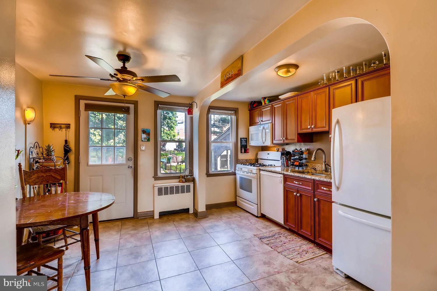 3703 Greenvale Road Baltimore, MD 21229 - Photo 5 of 24 a kitchen with refrigerator cabinets dining table and chairs