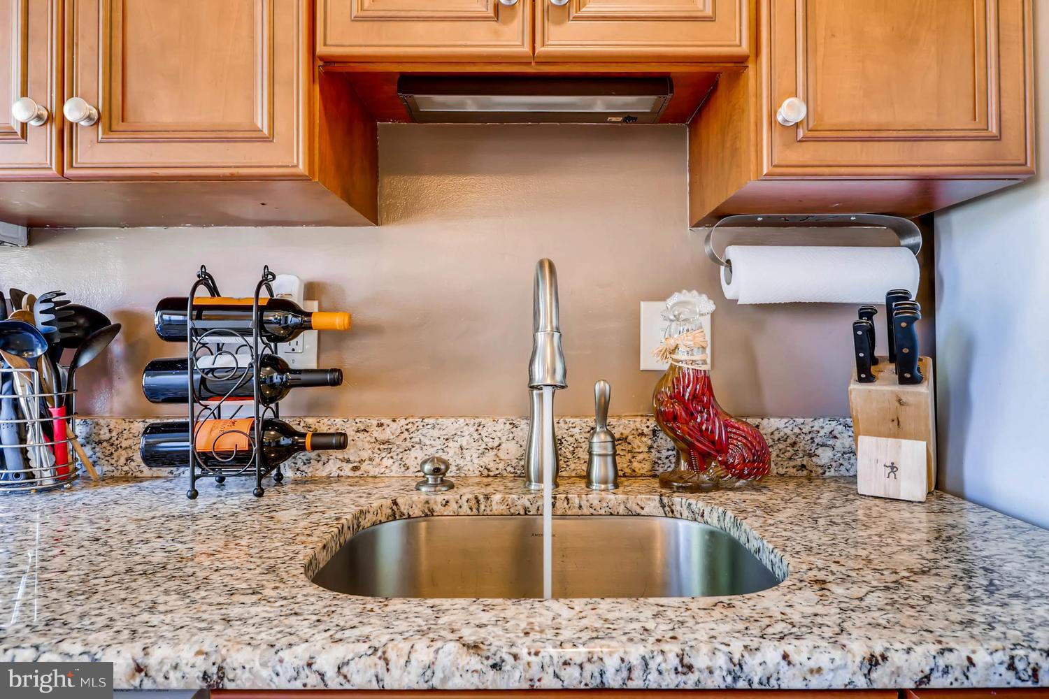 3703 Greenvale Road Baltimore, MD 21229 - Photo 9 of 24 a kitchen sink with granite countertop a sink and cabinets