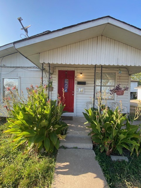 409 Chaparral Street Alice, TX 78332 - Photo 7 of 24 a couple of flower plants in front of door