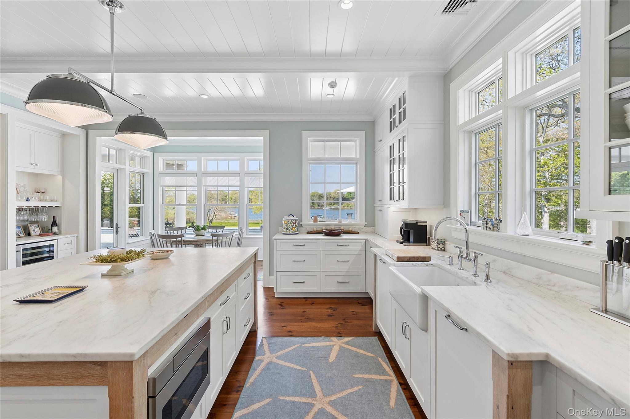 43 Old Main Road Quogue, NY 11959 - Photo 7 of 28 a large white kitchen with a large window