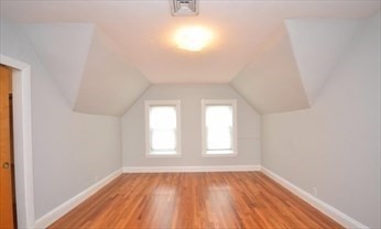 341 Summer Street, Unit 2F Somerville, MA 02144 - Photo 11 of 17 an empty room with wooden floor and windows