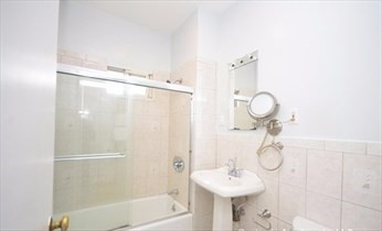 341 Summer Street, Unit 2F Somerville, MA 02144 - Photo 12 of 17 a bathroom with a shower a sink and mirror