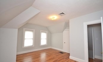341 Summer Street, Unit 2F Somerville, MA 02144 - Photo 15 of 17 a view of empty room with window and wooden floor