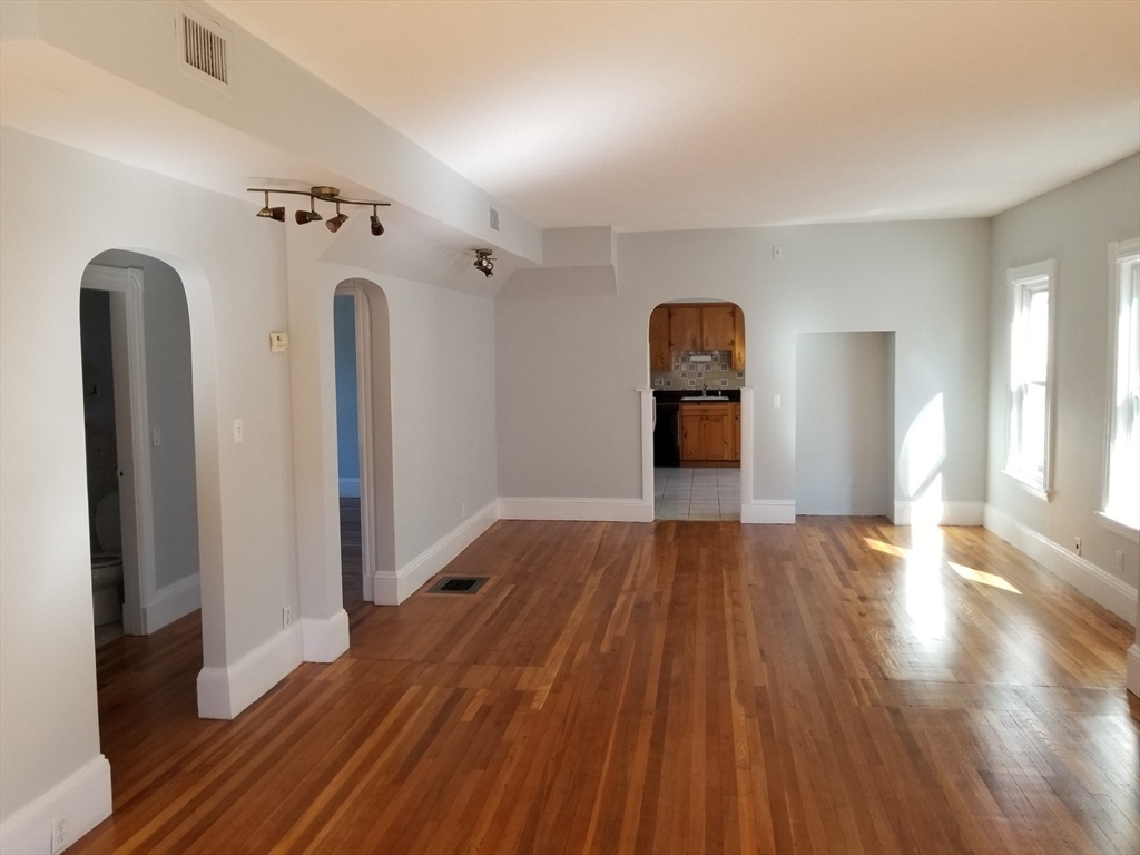341 Summer Street, Unit 2F Somerville, MA 02144 - Photo 2 of 17 a view of a room with wooden floor and ceiling fan