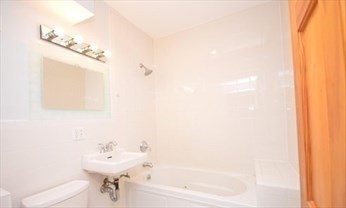 341 Summer Street, Unit 2F Somerville, MA 02144 - Photo 6 of 17 a bathroom with a sink and a mirror