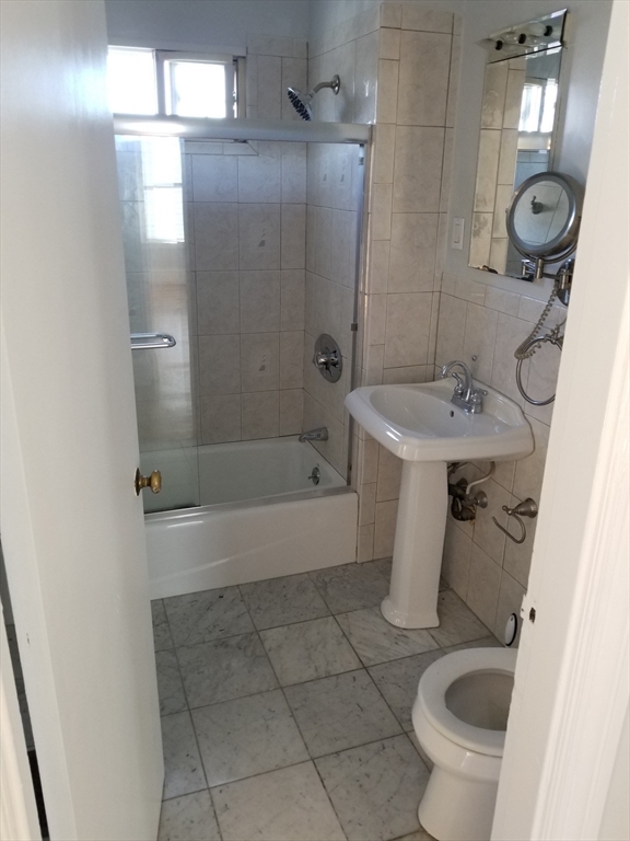 341 Summer Street, Unit 2F Somerville, MA 02144 - Photo 8 of 17 a bathroom with a sink a toilet and shower
