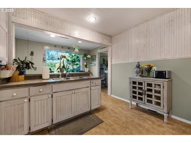 a kitchen with stainless steel appliances a sink and cabinets