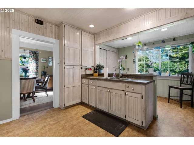 a kitchen with sink cabinets and window