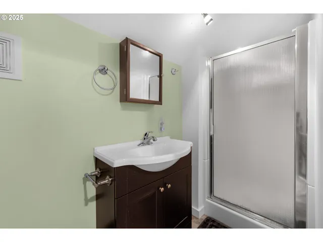a bathroom with a sink mirror and vanity