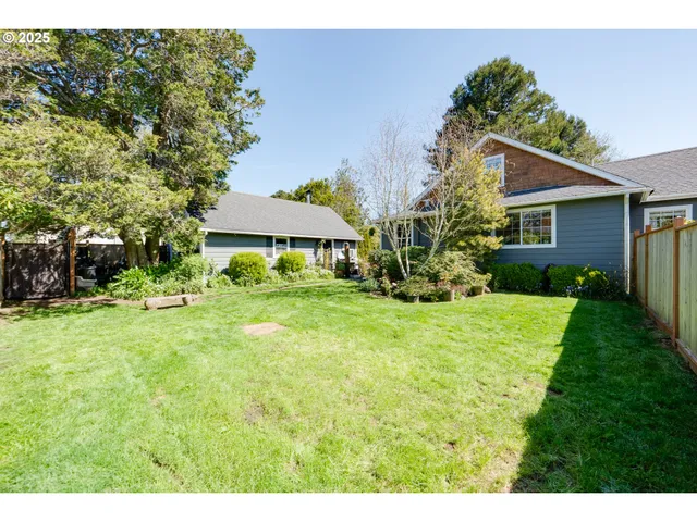 a backyard of a house with plants and tree