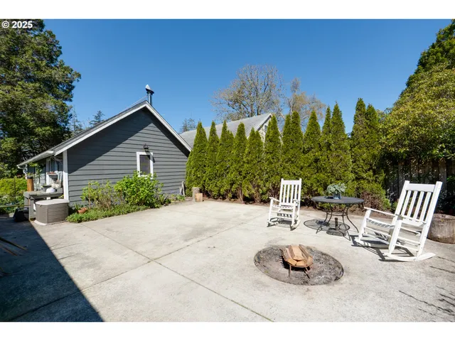 a view of a chairs and table in backyard