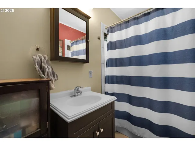 a bathroom with a sink a mirror and a shower
