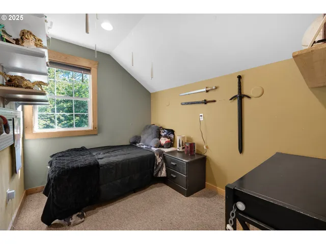 a living room with furniture a window and a flat screen tv