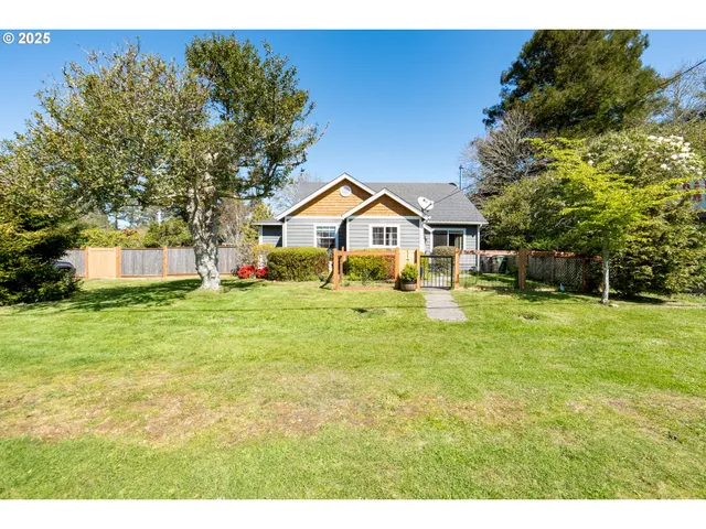 a front view of house with yard and green space