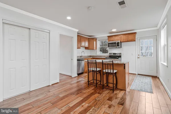 a view of a kitchen with dining room and wooden floor