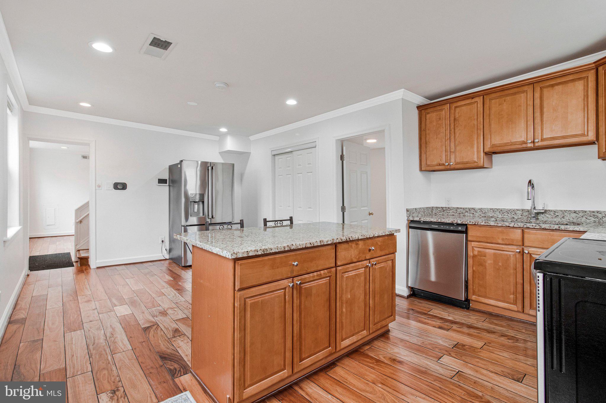 8600 Lantern Lane Clinton, MD 20735 - Photo 12 of 40 a kitchen with stainless steel appliances granite countertop a sink and cabinets